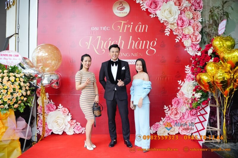 MC Tuấn Tú chụp hình với fan tại background do Minh Vũ Media thiết kế cho lễ tri ân khách hàng